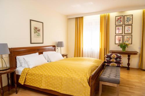 a bedroom with a bed with a yellow blanket at Hotel Krone Laupheim in Laupheim