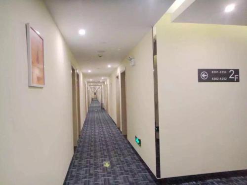 a long hallway with a sign on the wall at 7Days Inn Dongtai Hong Lan Road RT-Mart in Dongtai