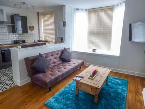 a living room with a couch and a coffee table at Flat 2 in Bridlington