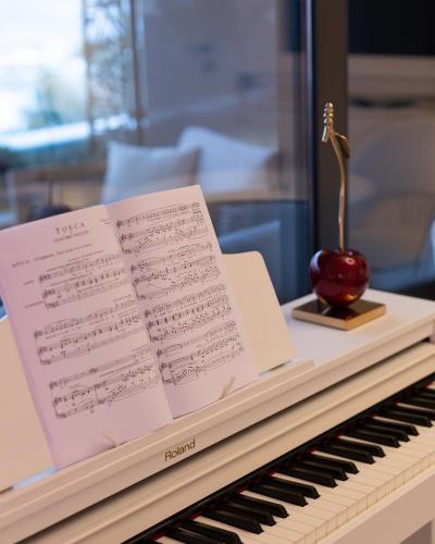 a piano with a sheet of music on it at Boutique Hotel Vissi d'Arte in Budva