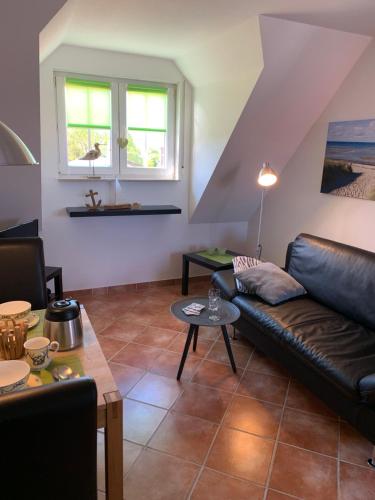 a living room with a couch and a table at Kirchseeblick 6 in Kirchdorf