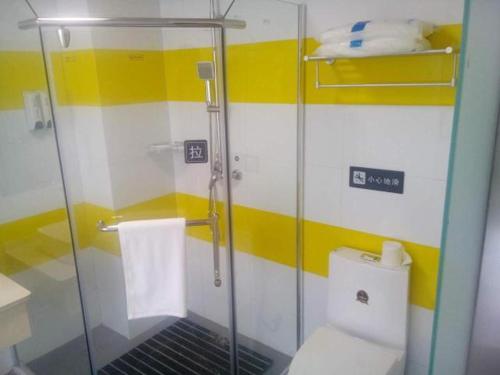 a bathroom with a glass shower and a toilet at 7Days Inn Huaian vehicle administration in Huai'an