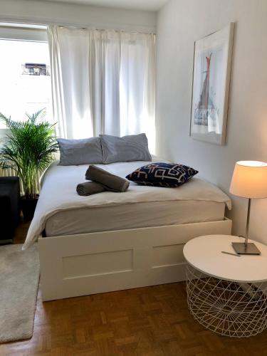 a bedroom with a bed with a table and a window at The Paquis Oasis in Central Geneva in Geneva