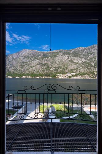 a view from a balcony with a view of a mountain at Palazzo Banicevic Luxury Rooms in Kotor