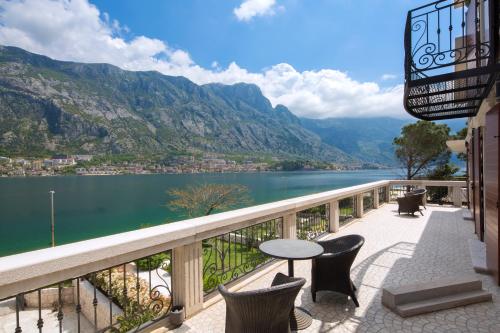a balcony with a view of a lake and mountains at Palazzo Banicevic Luxury Rooms in Kotor