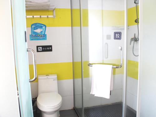 a bathroom with a toilet and a shower at 7Days Inn Rizhao Development Zone in Rizhao