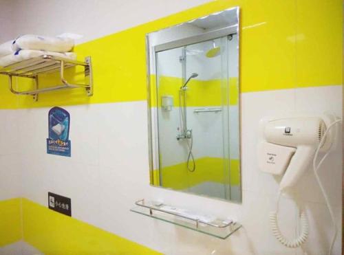 a bathroom with a shower and a mirror at 7Days Inn Yulin south gate bus station in Yulin