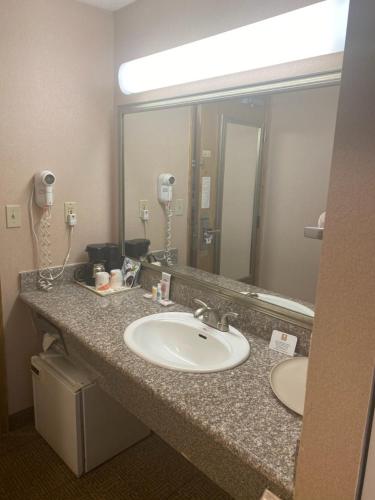 a bathroom with a sink and a large mirror at Comfort Inn Kirkland in Kirkland