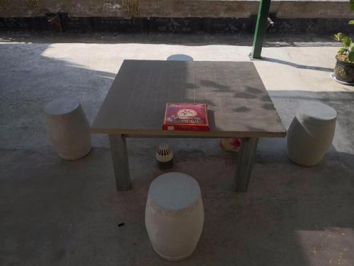 a wooden table with a book sitting on top of it at 7Days Inn Yanan East Street Bus Station in Yan'an