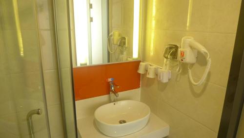 a bathroom with a sink and a shower at 7Days Premium Tangshan Xinhua Road University of science and engineering in Tangshan