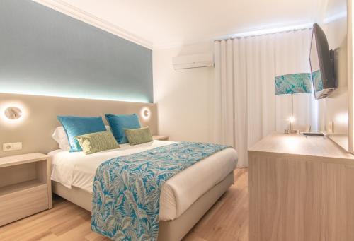 Postel nebo postele na pokoji v ubytování Loule Jardim Hotel