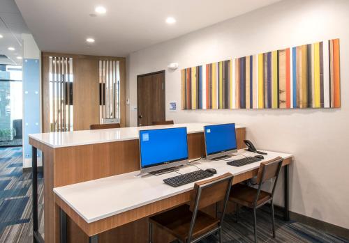 an office with two computers on a desk at Holiday Inn Express & Suites - Phoenix North - Happy Valley by IHG in Phoenix
