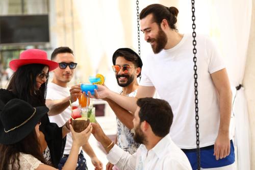 a group of people standing around drinking drinks at InterContinental Phoenicia Beirut by IHG in Beirut