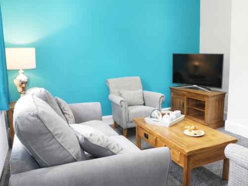 a living room with a couch and a tv at 7 Monkmoor Road in Shrewsbury
