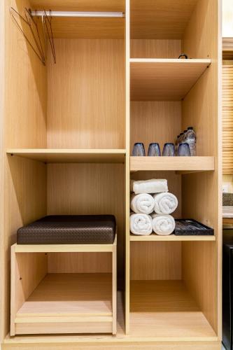 a walk in closet with wooden shelves and towels at Starry Home in Xiaoliuqiu