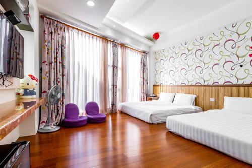 a hotel room with two beds and a fan at Starry Home in Xiaoliuqiu