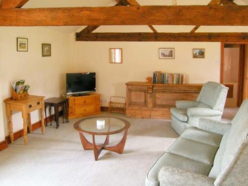 a living room with a couch and a table at The Granary in Craven Arms