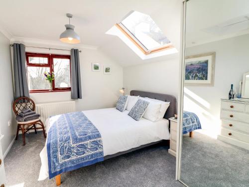 a bedroom with a bed and a mirror at Little Acorn in Barnstaple