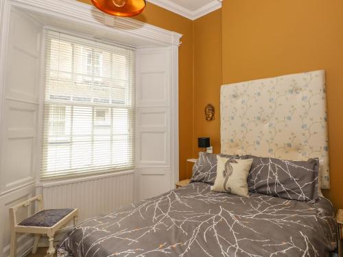 a bedroom with a bed and a window at Apartment 3 in Tenby