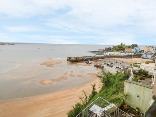 a view of a beach with sand and water at Apartment 3 in Tenby