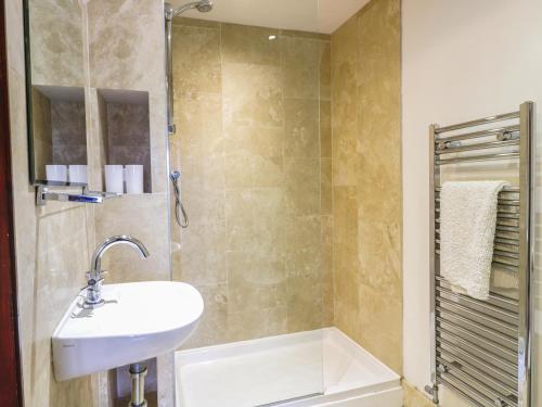 a bathroom with a sink and a shower at Brunnion House in Hayle
