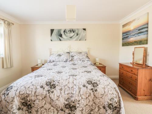 a bedroom with a bed and two night stands at 22 Trembel Road in Helston