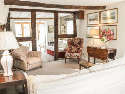 a living room with a couch and a bed at Lower Hodre in Bucknell