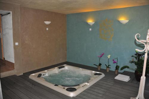 a jacuzzi tub in the corner of a room at Gte De Charme Le Cdre in Baron