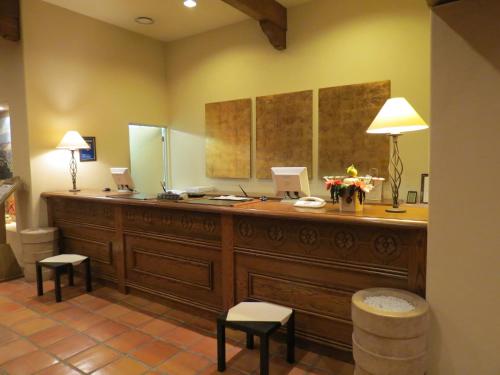 a room with a large wooden counter with stools at Poppy Springs Resort & Spa in Mimasaka