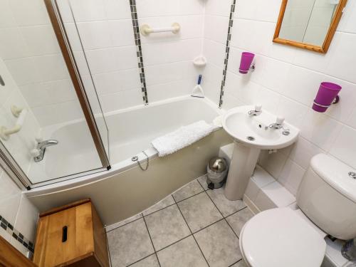 un bagno con lavandino, vasca e WC di Juniper Cottage ad Ambleside