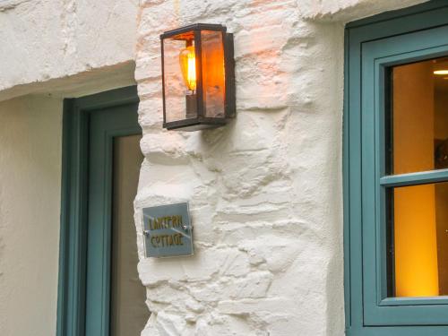 
a window that has a clock on it at Lantern Cottage, Padstow in Padstow
