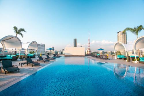 a large swimming pool on the roof of a building at Luxent Hotel in Manila
