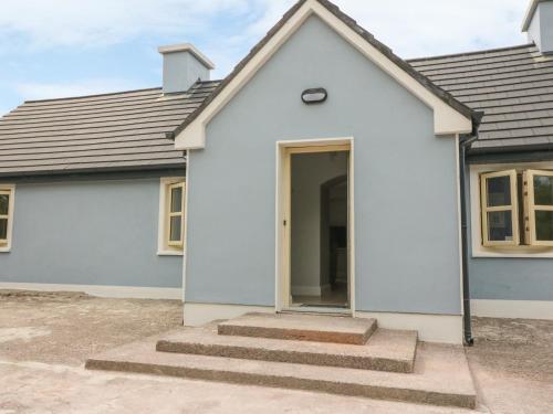 a white house with stairs in front of it at Dromstabla in Glencar