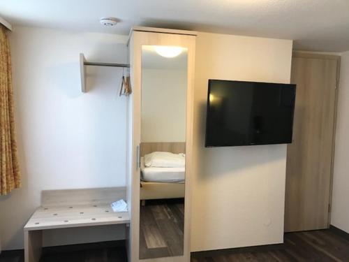 a room with a flat screen tv on a wall at Landgasthof Hotel Rittmayer in Hallerndorf