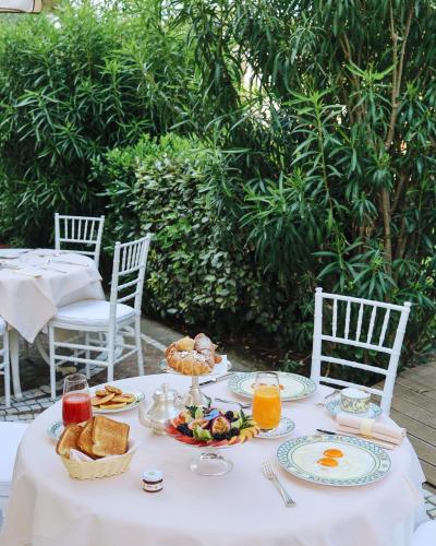 a white table with breakfast food on it at Palace Hotel in Milano Marittima