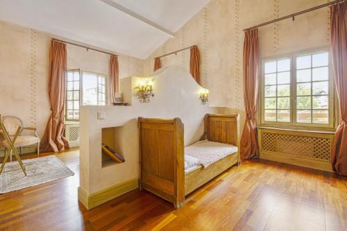a large room with a bed and windows at Hotel Villa Catarie in Guéthary
