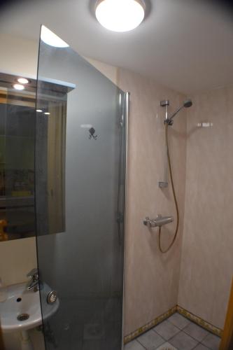 a bathroom with a shower with a glass door at Kajaka Beach Area Holiday Home in Pärnu
