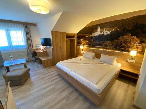 a bedroom with a bed with a view of a building at Privatzimmer und Ferienwohnungen Leeb in Persenbeug-Gottsdorf