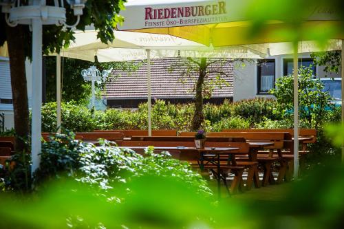 a restaurant with tables and chairs and an umbrella at Landhotel Schneider in Riedenburg