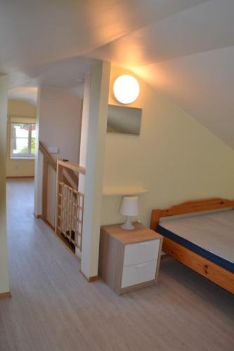 a bedroom with a bed and a table with a lamp at Kajaka Beach Area Holiday Home in Pärnu