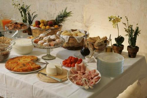 a table with food and baskets of food on it at Masseria Montelauro in Otranto