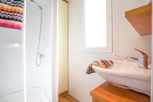a bathroom with a sink, toilet and bathtub at Camping Village Mare Pineta in Sistiana