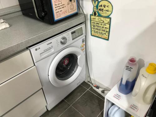 a washing machine in a kitchen next to a washer at 24 Guesthouse Jeonju in Jeonju