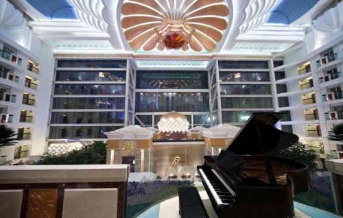a piano in front of a building with a ceiling at Nanjing Central Hotel in Nanjing