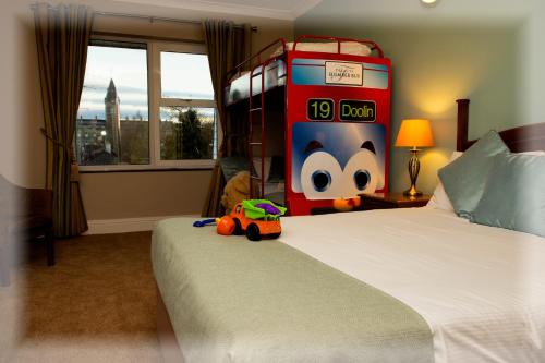 a bedroom with a bed with a toy truck on it at Treacys West County Conference and Leisure Centre in Ennis