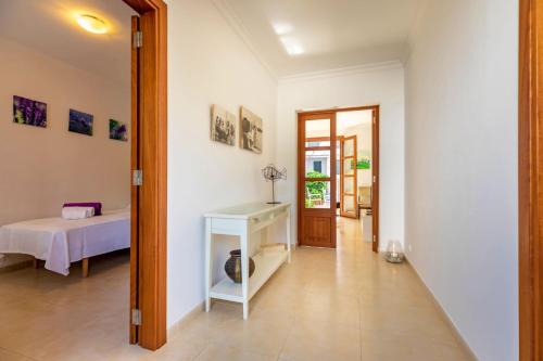 a hallway with a room with a bed and a table at Casa Antonia in Port de Pollensa
