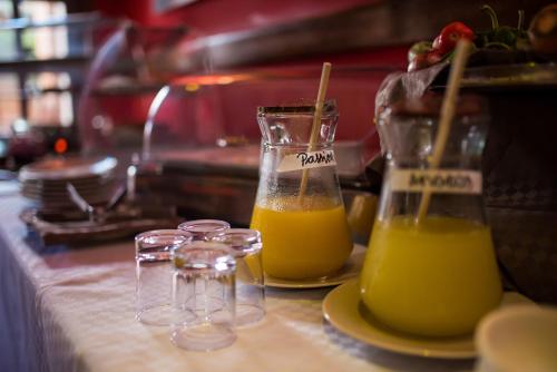 two glasses of orange juice sitting on a counter at Les 3 Métis in Antananarivo