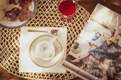 a table with a plate of food and a cup of tea at Il Mandorlo - Agriturismo e Azienda Agricola Ferrato in Ancona