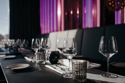 a group of wine glasses sitting on a table at Airport Plaza Hotel Hamburg in Norderstedt
