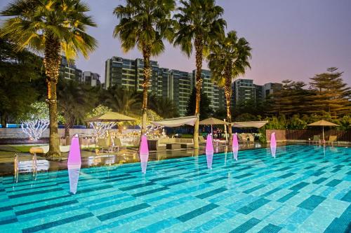 a swimming pool with pink dolphins in a resort at Crowne Plaza Guangzhou Huadu by IHG - Free Shuttle bus between hotel to Exhibition Center During Canton Fair in Guangzhou